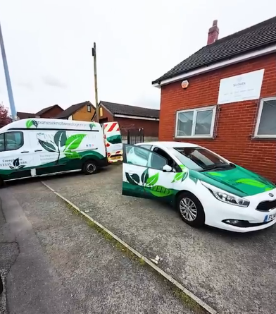 JKWA survey team arriving at the Scout Hut in Swinton for Japanese knotweed remediation, with branded vehicles parked outside the red brick Scout Hut building